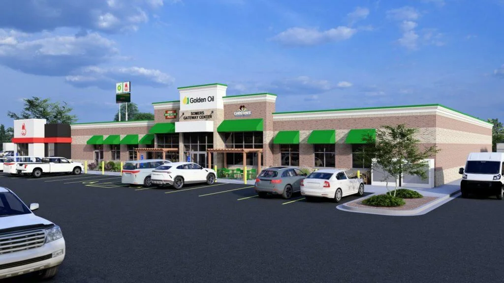 Image of Golden Oil gas station located in Somers Gateway Center, featuring green awnings and a modern brick facade. A variety of vehicles are parked in front, with prominent signage visible, highlighting nearby businesses, including Chester's and a pizza restaurant. The scene captures a sunny day with a clear blue sky.